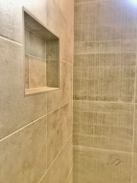 Tile shower wall with shower shelf installed by Floored by Barrett in the Temple Belton area