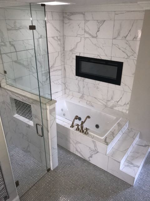 White Marble Tile Shower Tub Shower Surround and walls with intricate tile floor installed by Floored by Barrett in the Temple Belton area