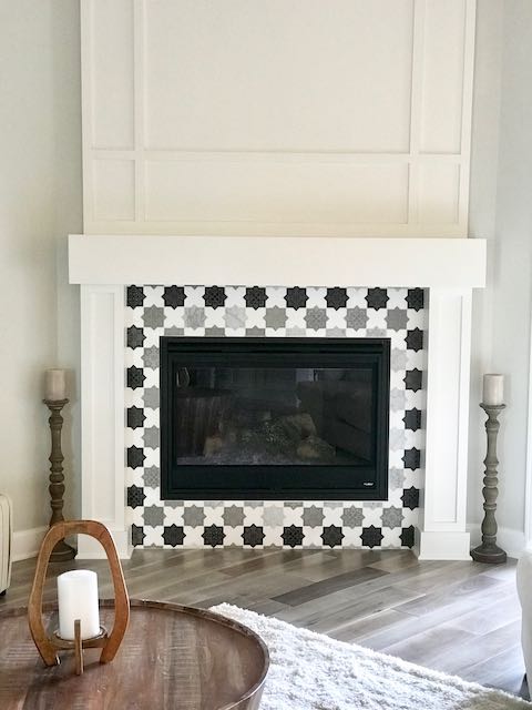 Tile fireplace surround and grey hardwood floor installed by Floored by Barrett in the Temple Belton area