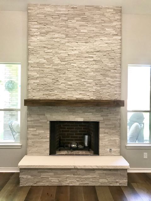 Grey stonework fireplace and hardwood floor installed by Floored by Barrett in the Temple Belton area