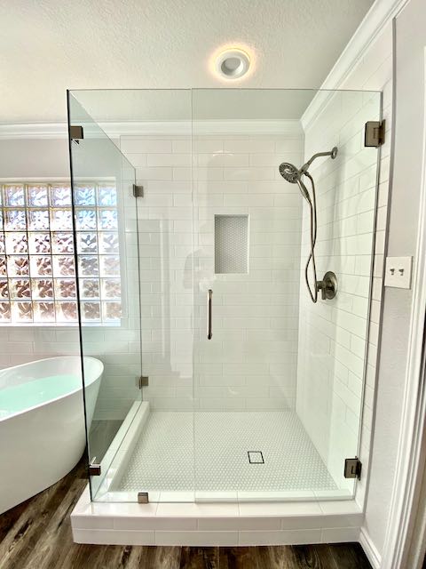White Tile Shower with Round tile Shower shelf and floor installed by Floored by Barrett in the Temple Belton area