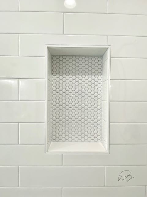 White Tile Shower with Round tile Shower shelf installed by Floored by Barrett in the Temple Belton area