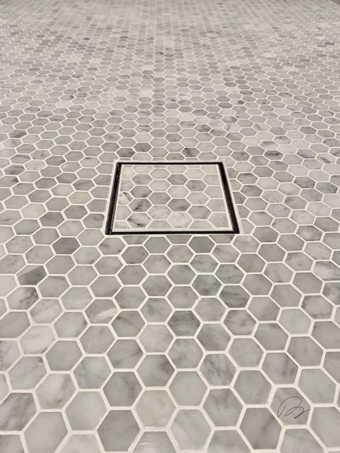 Grey Hexagonal Tile Shower Floor and Drain installed by Floored by Barrett in the Temple Belton area