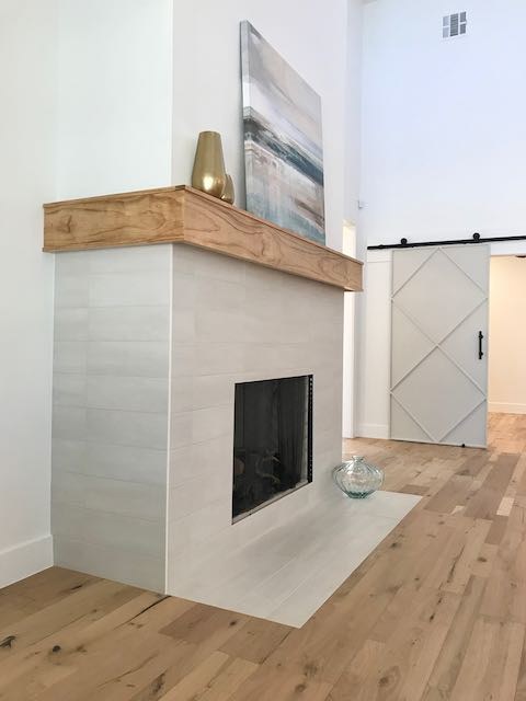 Grey Tile Fireplace surrounded by hardwood installed by Floored by Barrett in the Temple Belton area