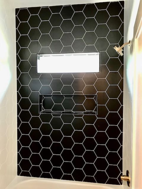 Black Hexagonal Tile shower wall installed by Floored by Barrett in the Temple Belton area
