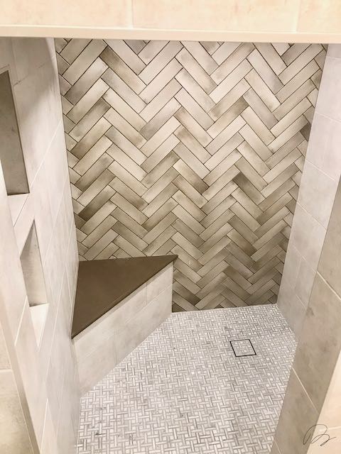 Tile shower with corner seat installed by Floored by Barrett in the Temple Belton area